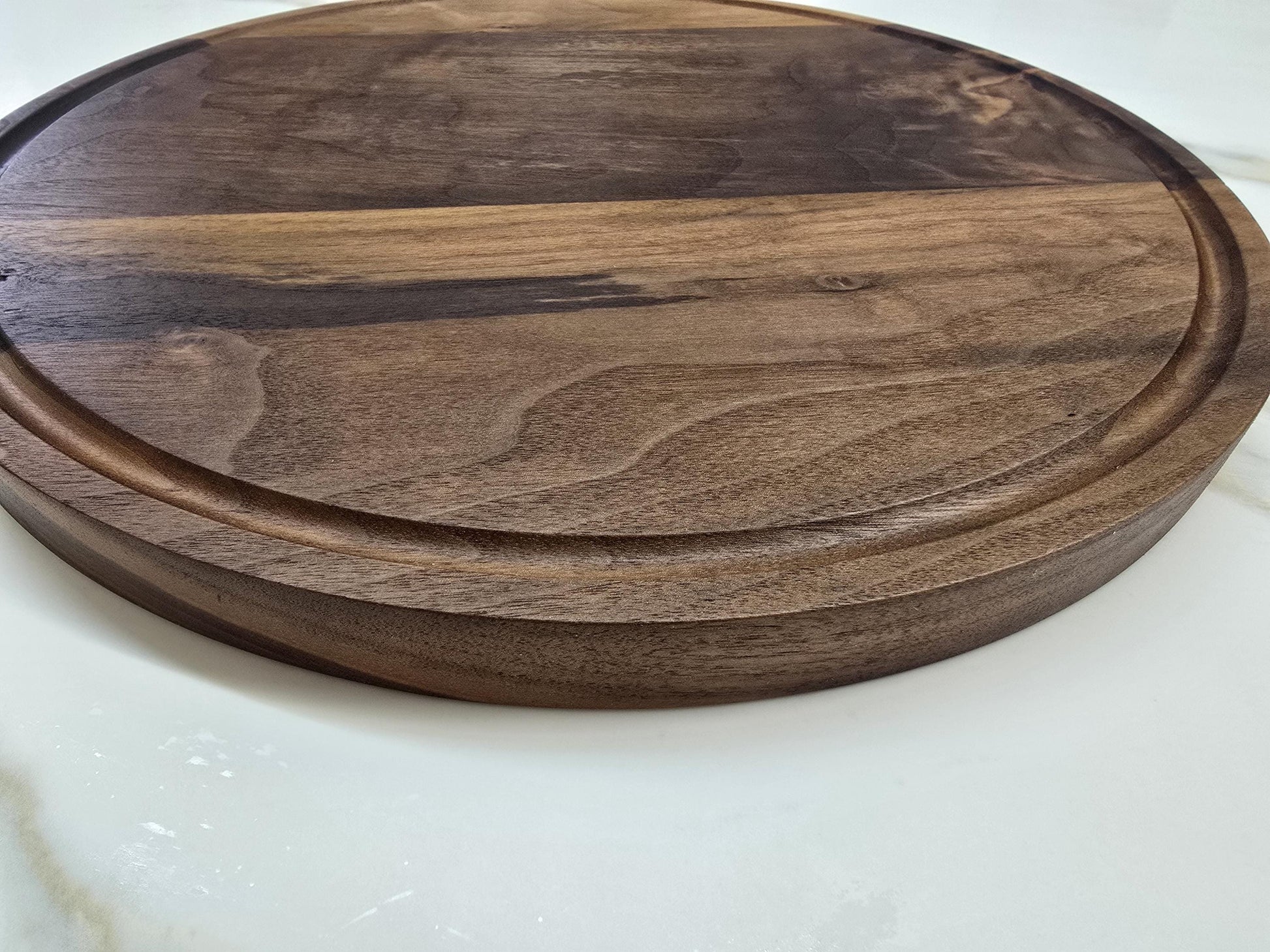 Round black walnut cutting board